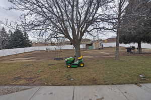 View of yard featuring a storage unit