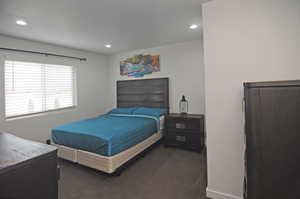 Bedroom with dark carpet