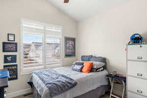 Bedroom with vaulted ceiling, carpet, and ceiling fan