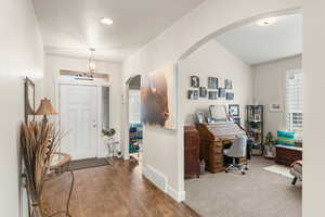 Entrance foyer with hardwood / wood-style floors, plenty of natural light, and a textured ceiling