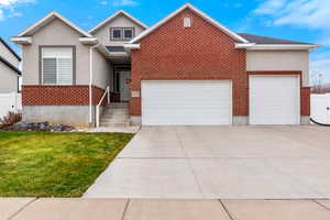 View of front of home with a garage and a front yard