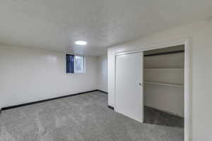 Unfurnished bedroom featuring carpet flooring and a closet