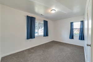 Carpeted empty room featuring a wealth of natural light