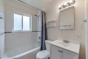 Full bathroom featuring vanity, toilet, and shower / bath combo with shower curtain