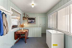 Clothes washing area with a textured ceiling