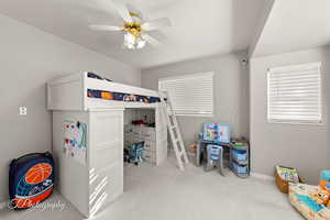 Carpeted bedroom with ceiling fan