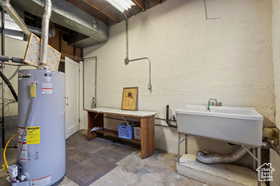 Basement featuring water heater and sink