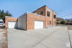 View of property exterior featuring a garage and a mountain view