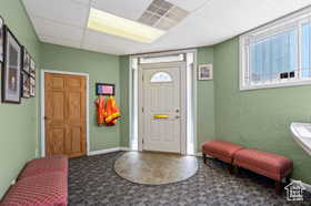 Foyer with a paneled ceiling and a healthy amount of sunlight