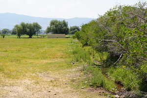 View of local wilderness featuring a rural view and a mountain view