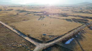 Aerial view featuring a rural view and a mountain view