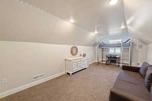 Interior space with vaulted ceiling and carpet floors