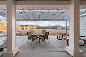 View of patio with a storage shed and a pergola