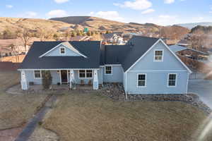 View of front facade featuring a mountain view and a front lawn