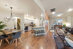 Dining room with hardwood / wood-style flooring and a notable chandelier