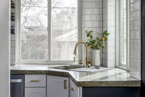 Details featuring white cabinetry and sink