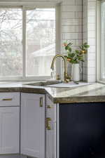 Interior details featuring sink and white cabinets