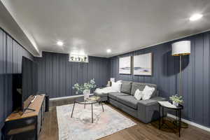 Living room with dark hardwood / wood-style flooring