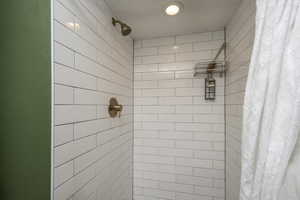 Bathroom featuring curtained shower