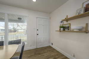 Entrance foyer with dark hardwood / wood-style flooring