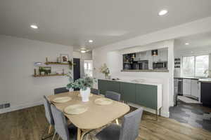 Dining area with hardwood / wood-style flooring and sink