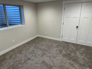 Unfurnished bedroom featuring carpet flooring and a closet