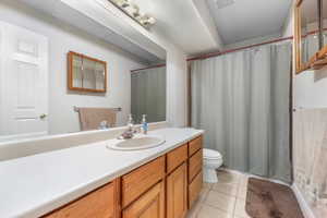 Bathroom with tile patterned flooring, vanity, and toilet