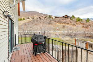 Deck with a mountain view and grilling area