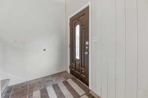 Foyer with wood walls