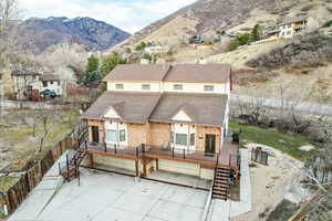 Back of house featuring a garage and a mountain view