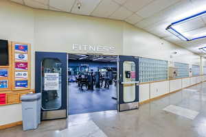 Exercise room with a mail area and a drop ceiling