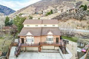 Rear view of property featuring a garage and a mountain view