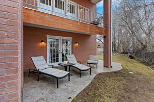 View of patio with french doors and a balcony