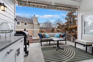 View of patio featuring a balcony, an outdoor hangout area, and grilling area