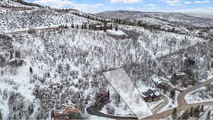 Snowy aerial view featuring a mountain view