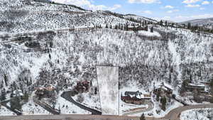 Snowy aerial view featuring a mountain view