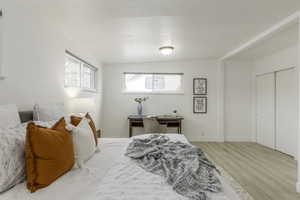 Bedroom with wood-type flooring and a closet