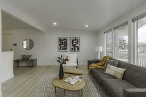 Living room featuring light hardwood / wood-style floors and beamed ceiling