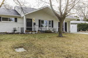 Ranch-style home with a front lawn