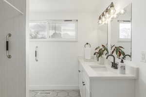 Bathroom featuring vanity and a tile shower