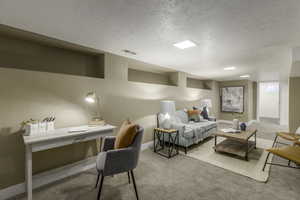 Living room with light colored carpet and a textured ceiling