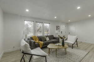 Living room with light hardwood / wood-style flooring