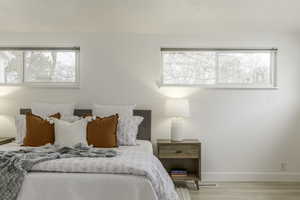 Bedroom with light hardwood / wood-style flooring