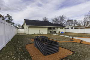 Rear view of house featuring a lawn