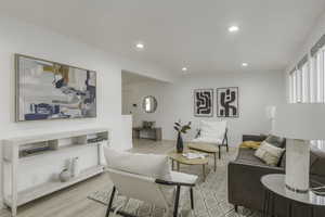 Living room with light hardwood / wood-style flooring