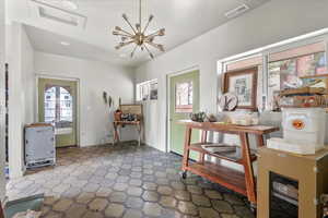 Foyer with a notable chandelier and a wealth of natural light