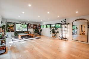 Workout area with plenty of natural light and light wood-type flooring