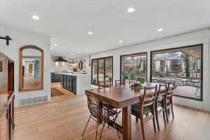 Dining area with light hardwood / wood-style flooring and a barn door