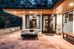 View of patio with french doors and an outdoor fire pit