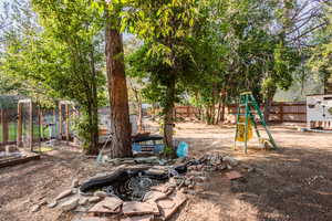 View of yard with an outdoor structure and a playground